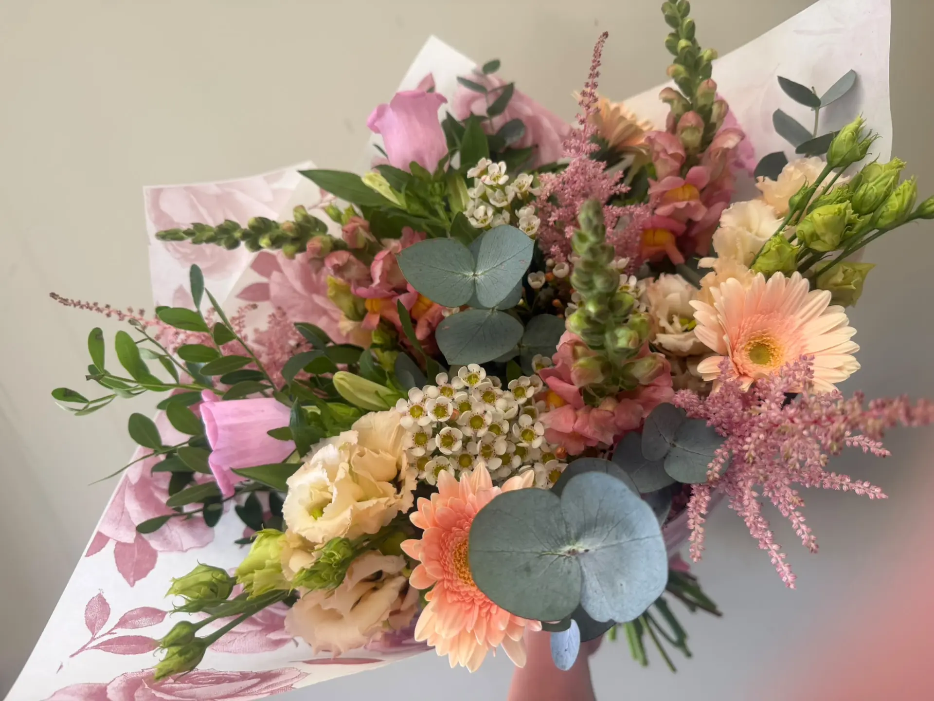 Pastel hand-tied bouquet with gerbera, lisianthus and waxflower