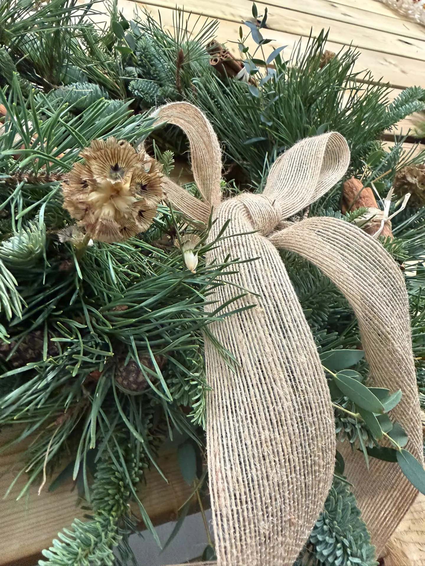 Rustic Christmas wreath with pine needles, eucalyptus and a natural burlap bow