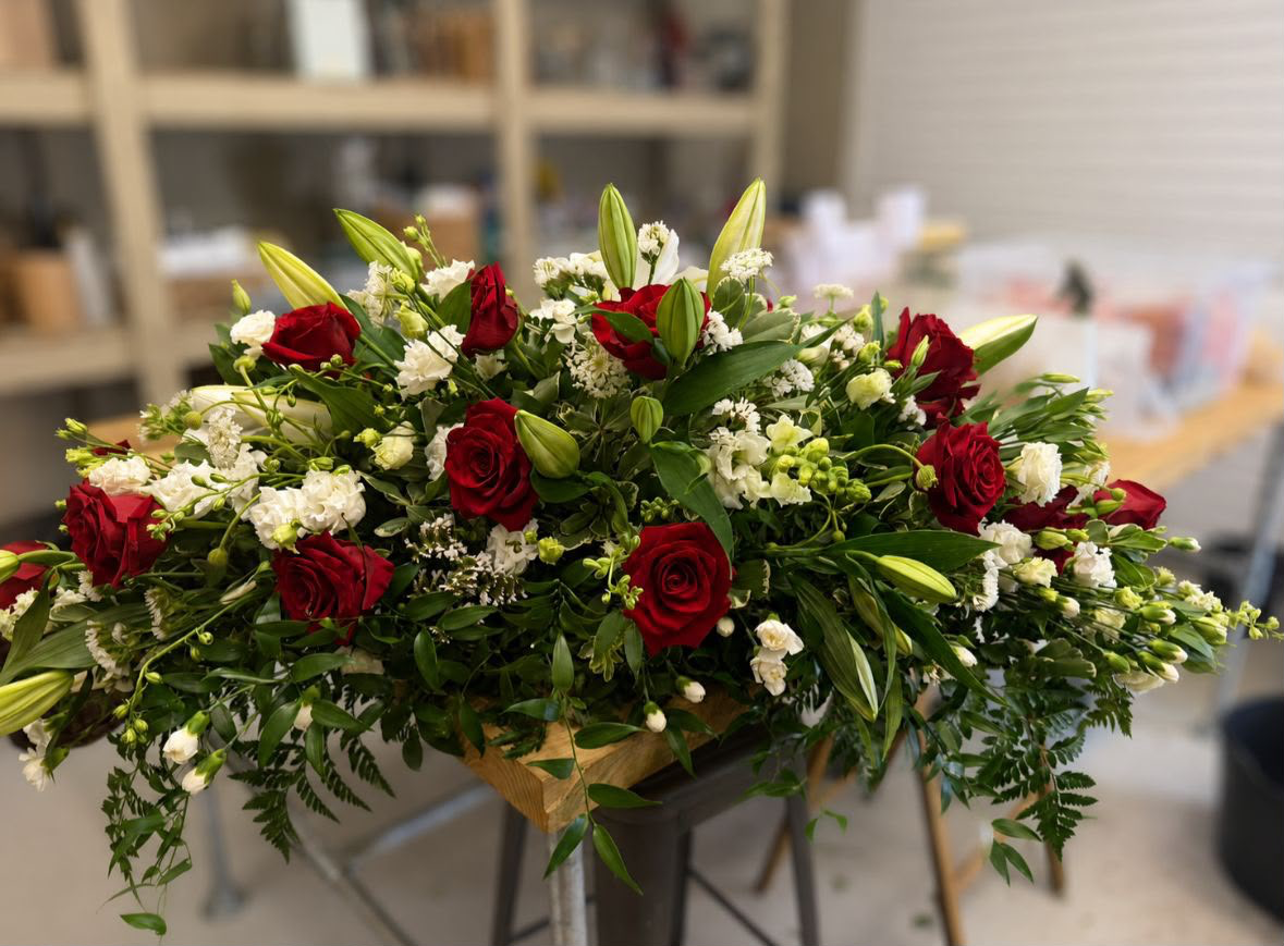 Red rose and white carnation coffin spray with lilies