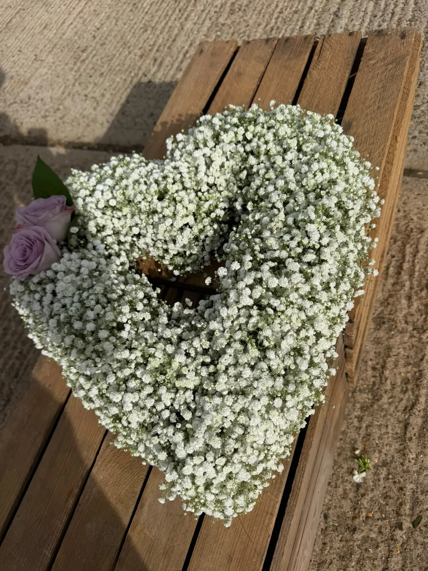 Open heart tribute of gypsophila with lilac roses