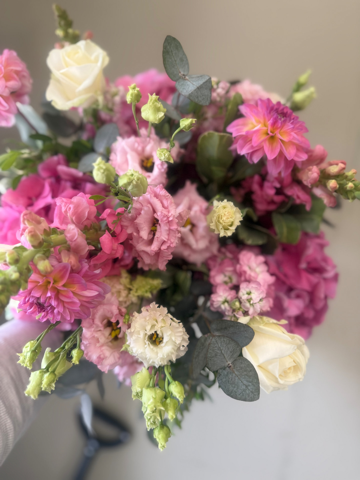 Close-up of a bouquet in blush pink, white and soft green